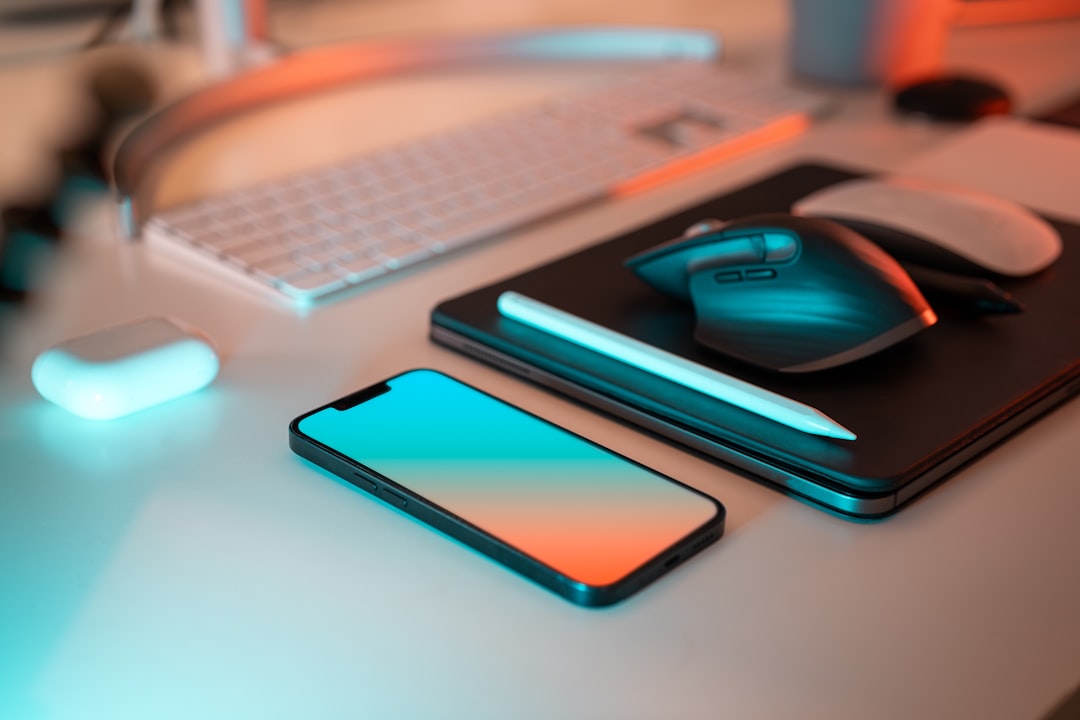 Photo by Jakub Żerdzicki a laptop, mouse, and cell phone on a desk