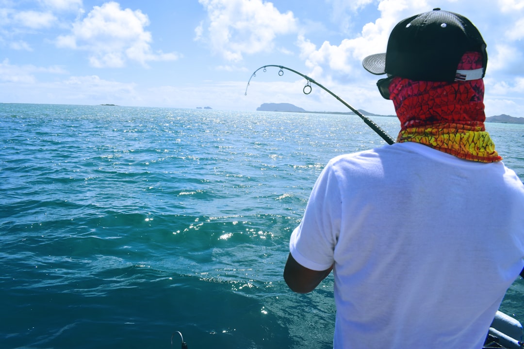 Photo by Drew Farwell man holding fishing rod